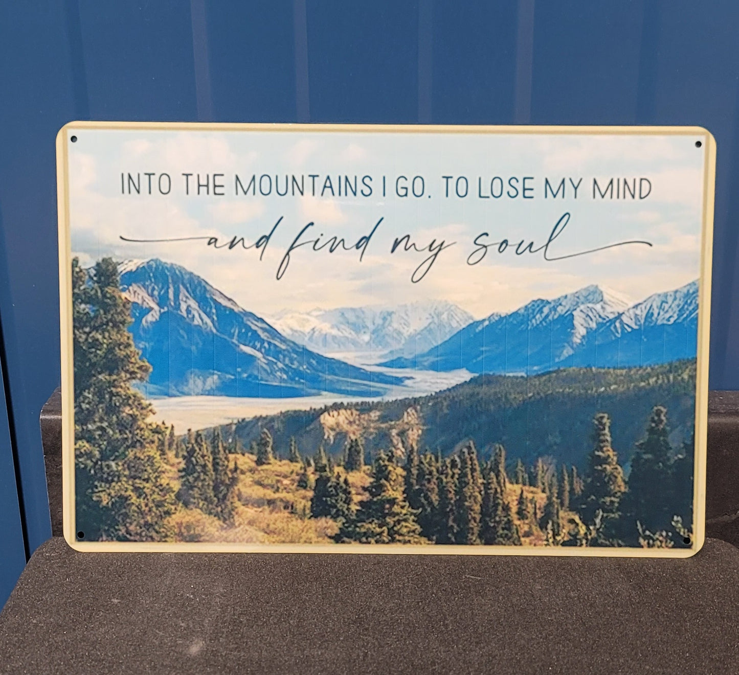 Into the mountains metal sign