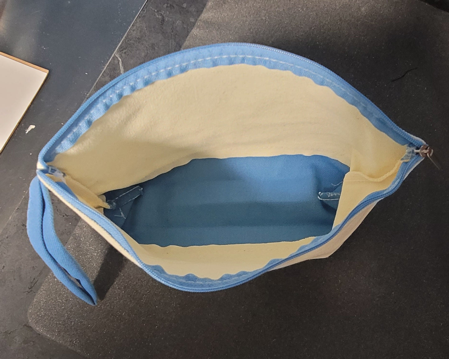 Zippered bag with handle and colored bottom