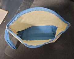Zippered bag with handle and colored bottom